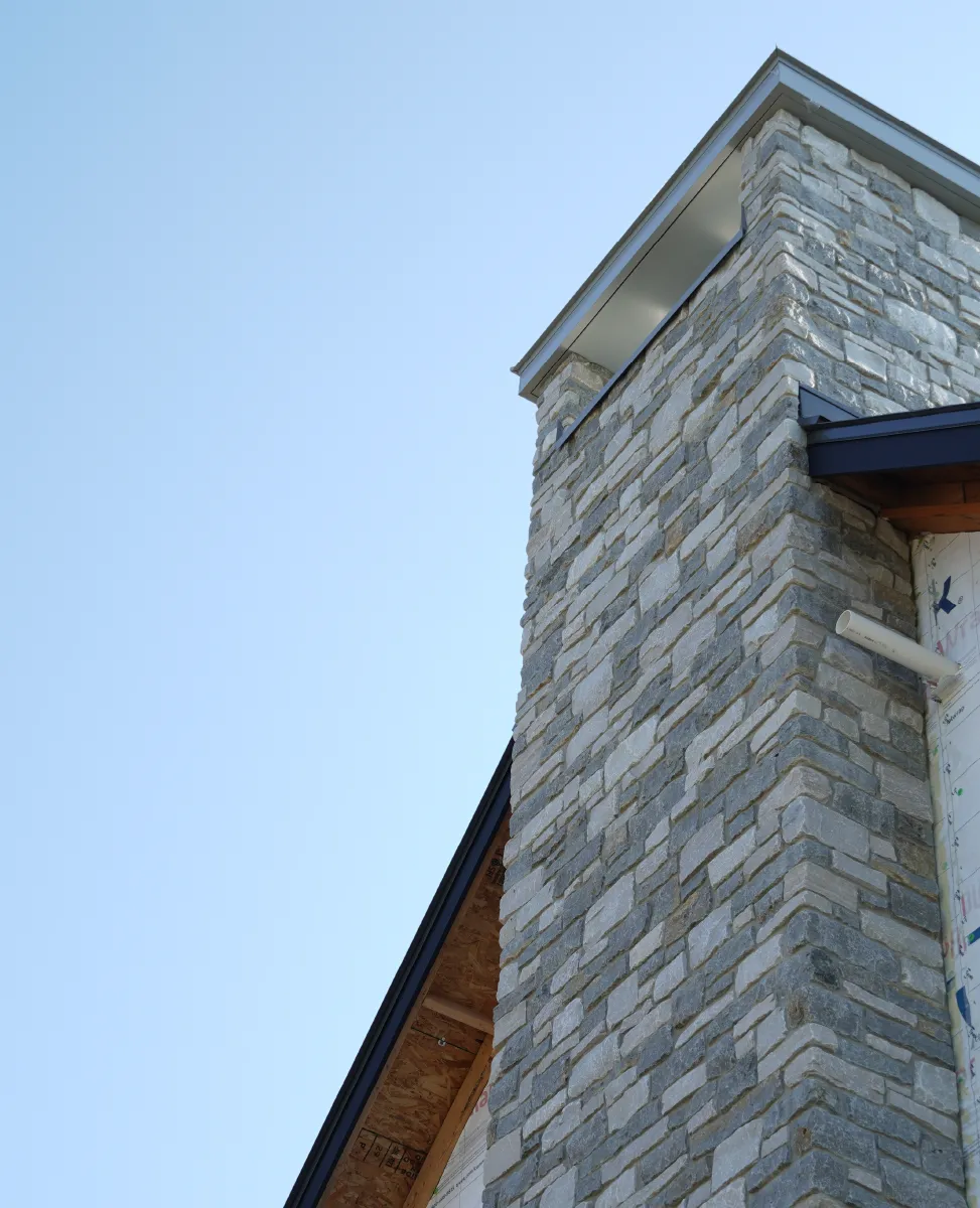 Chimney with masonry stone work on commercial building