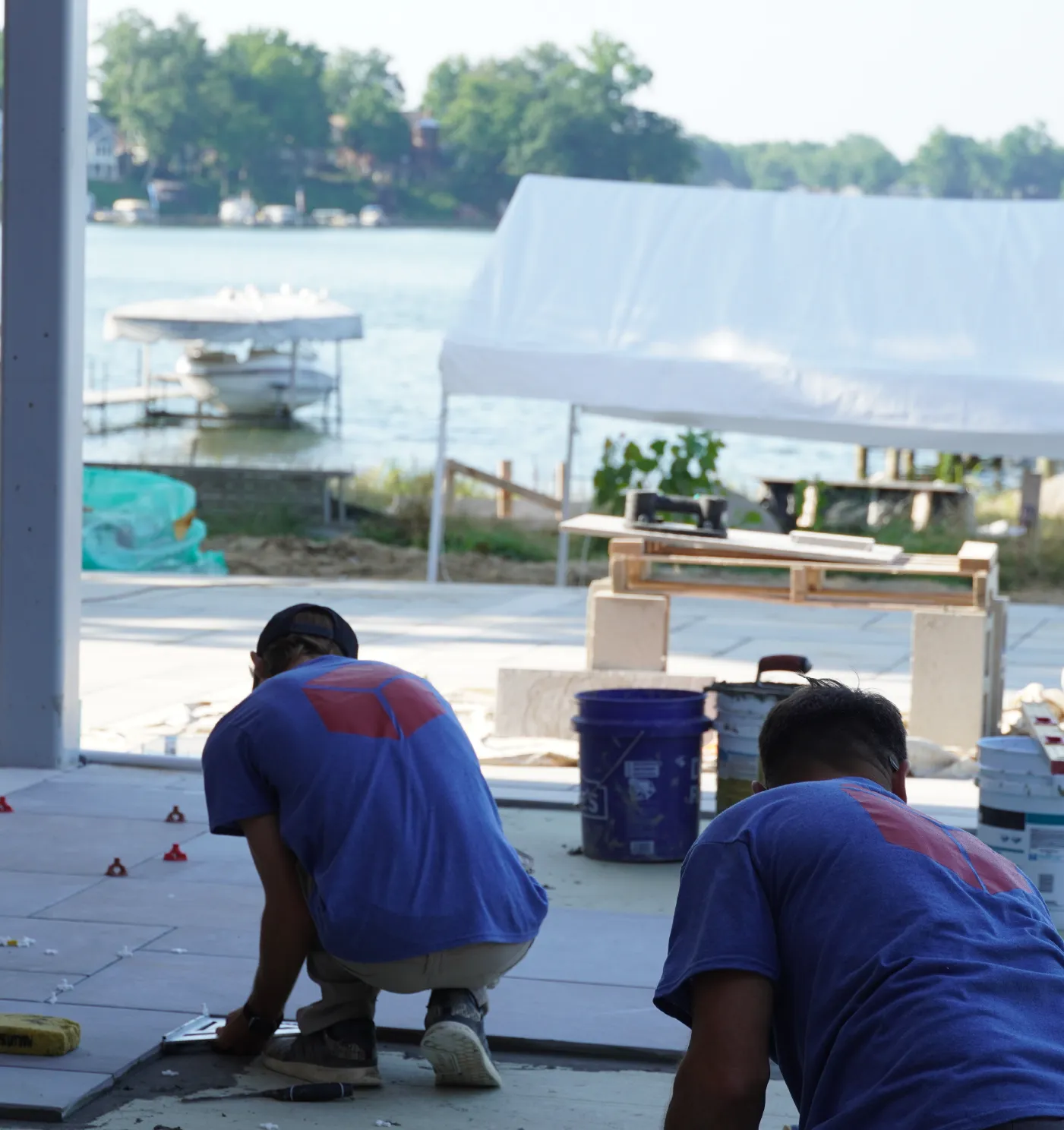 Ophoff masonry employees laying outdoor stone tile at a lakefront home in Michigan.