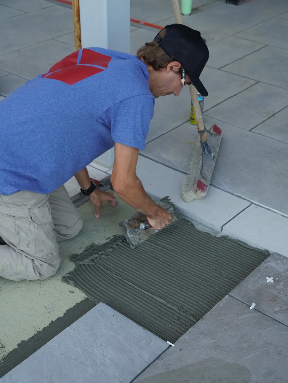 Ophoff masonry employee laying stone tile at residential home