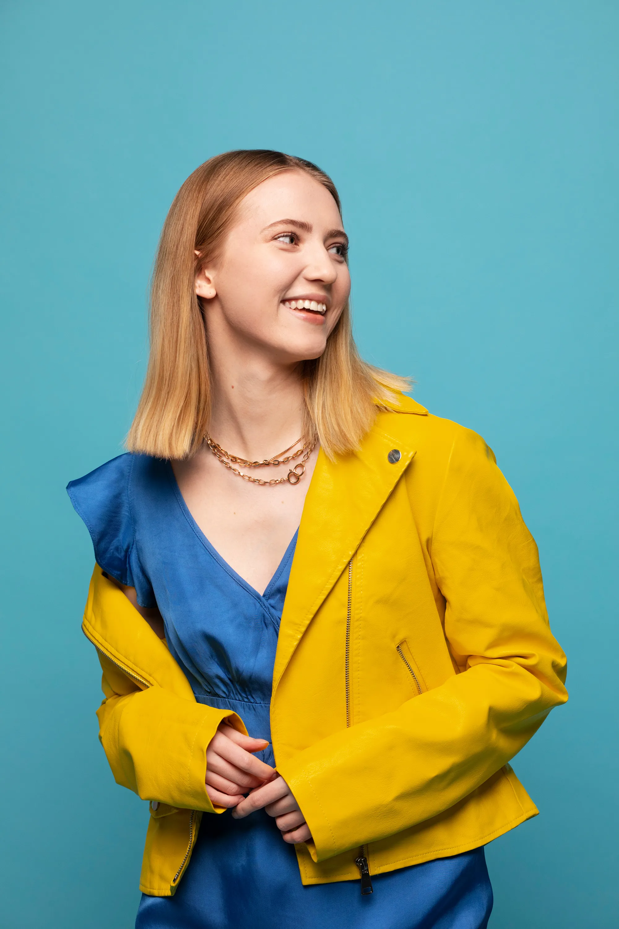 Woman in yellow jacket on a blue background