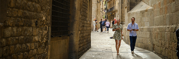 Travelers exploring a historic Mediterranean street
