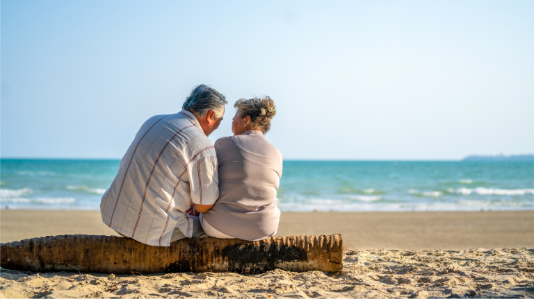 Senior couple sitting on the beach