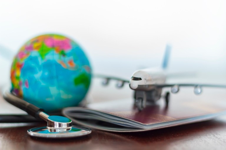 Travel insurance documents and globe