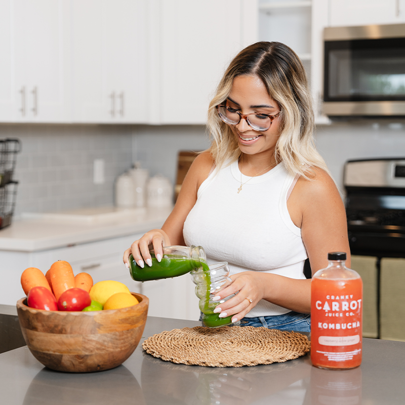 Francesca serving herself green juice