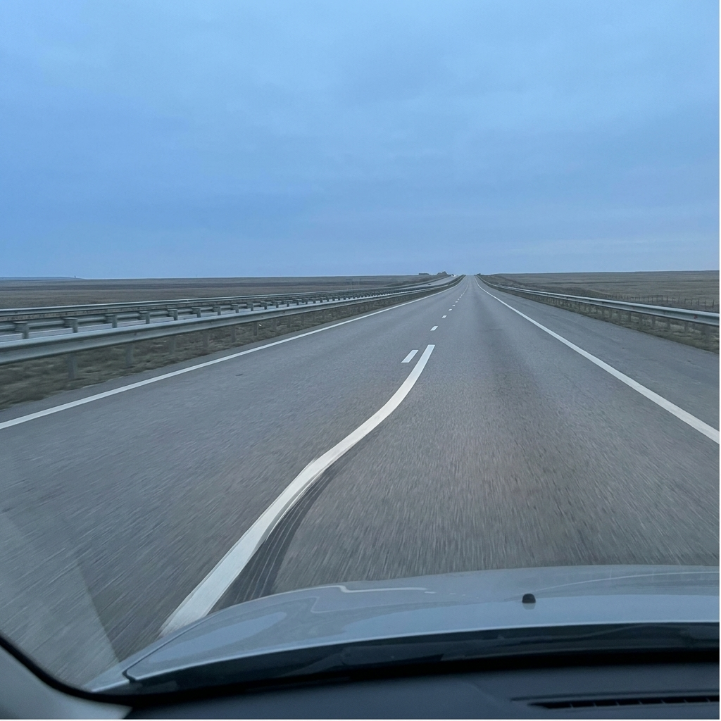 Gentle lane drift on a monotonous highway.