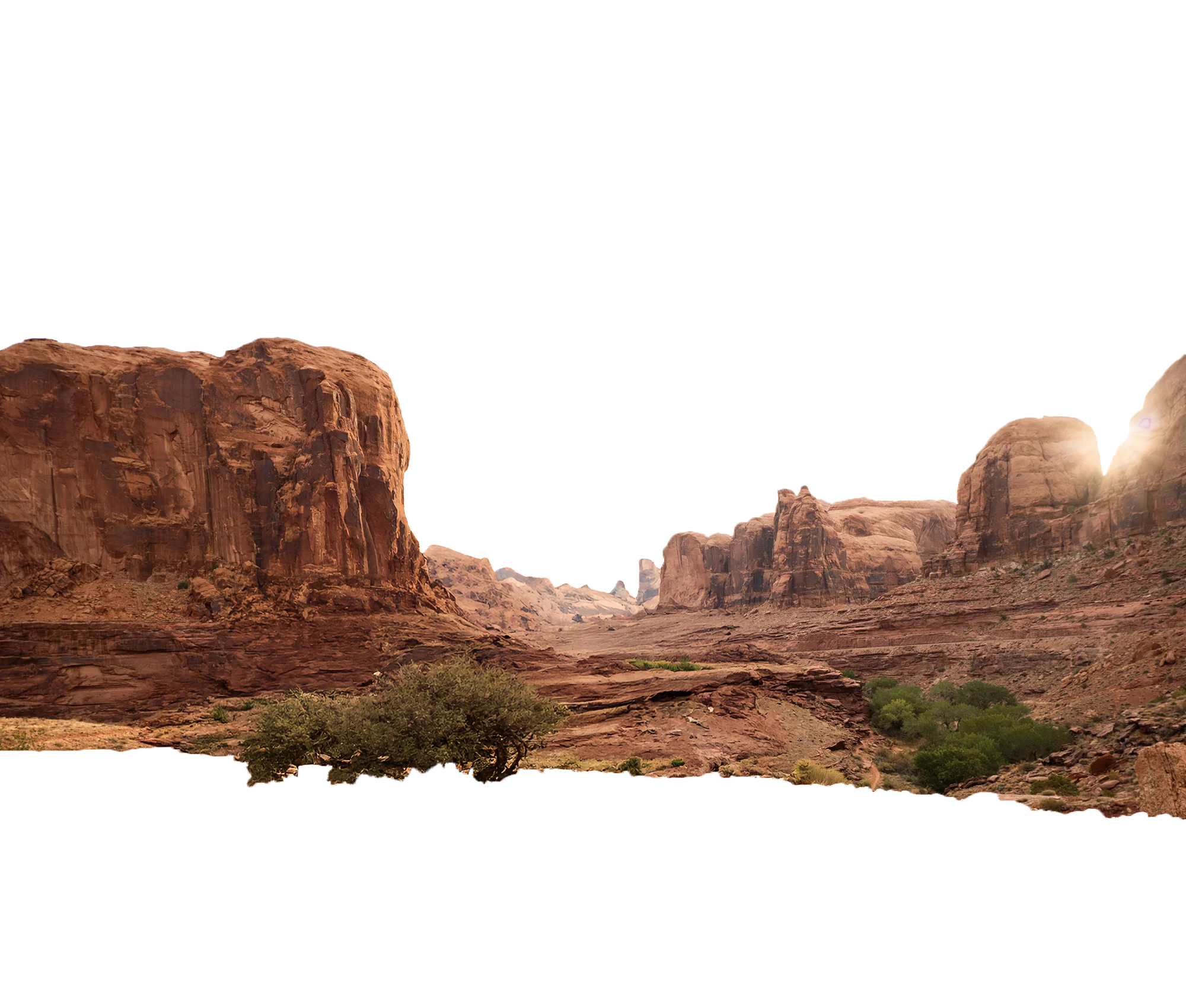 Sunlight peeking over red rock cliffs in a desert canyon with sparse green trees and bushes.