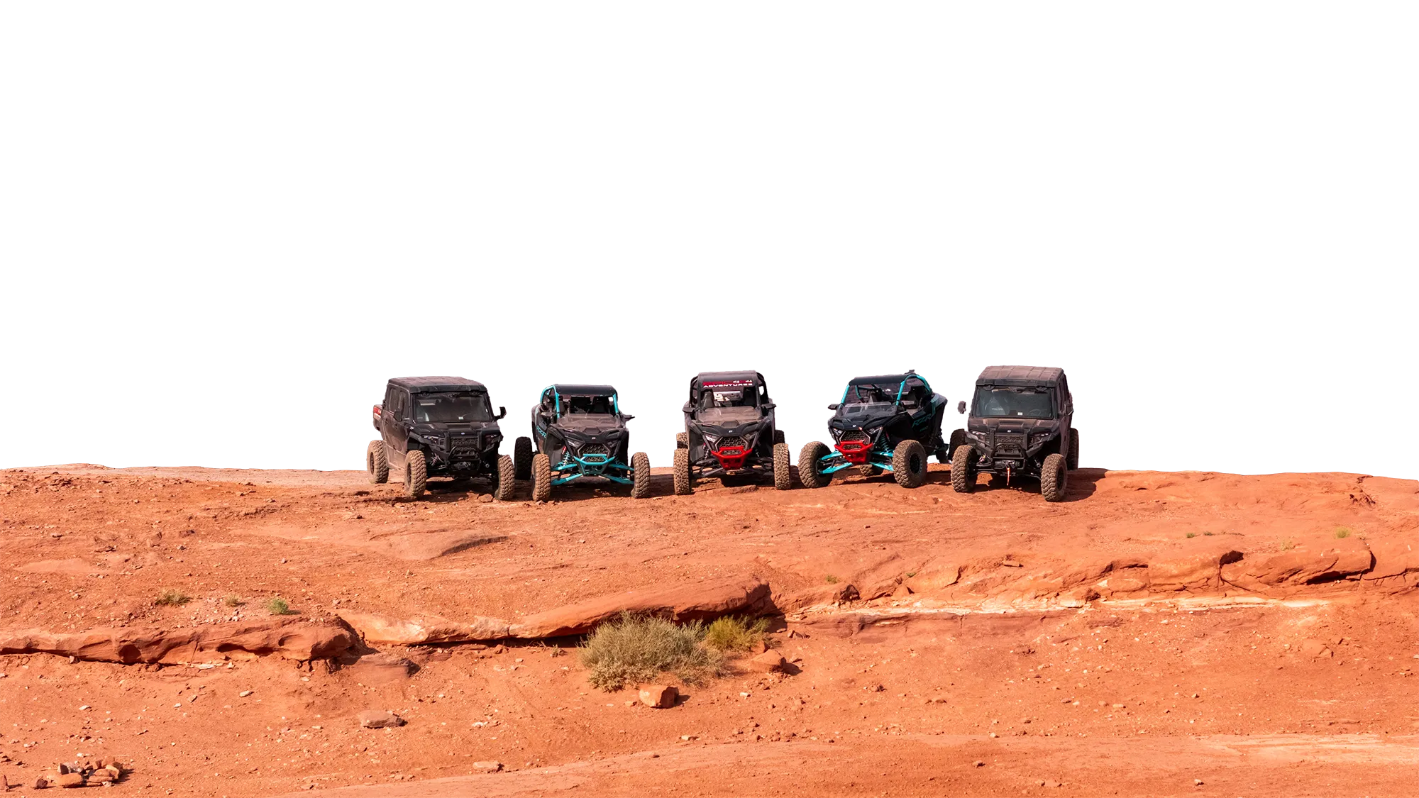 Five off-road vehicles parked side by side on a red dirt terrain under clear sky.