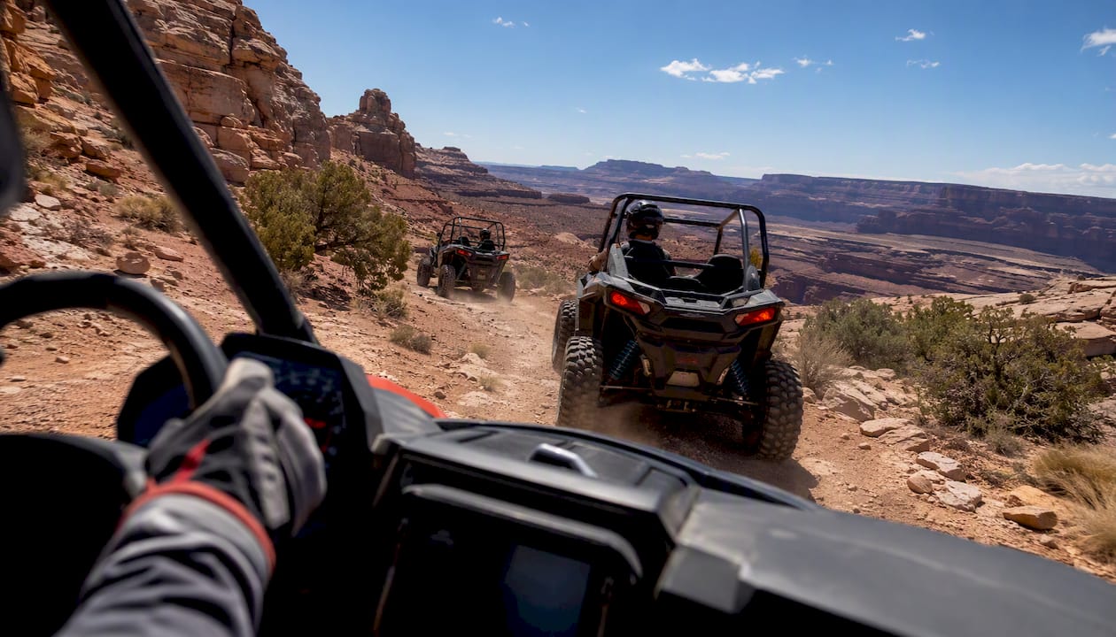 Riders on guided UTV tour navigating varied Moab terrain