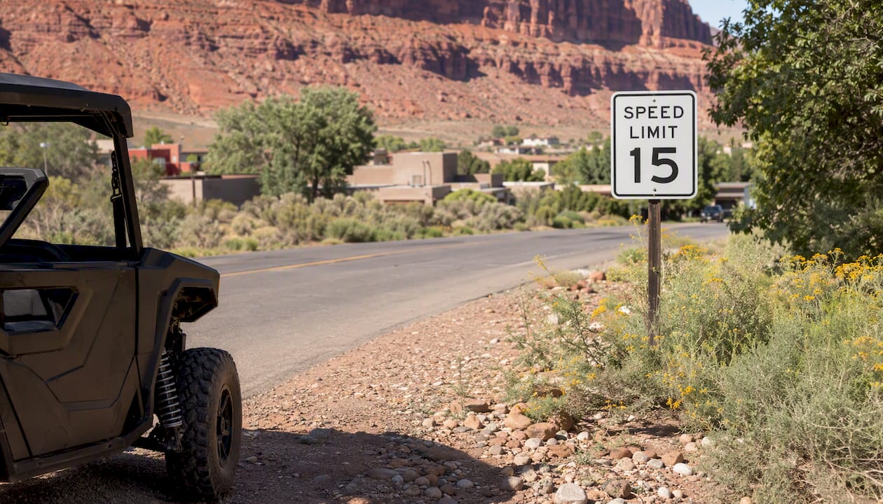 Speed limit sign and partial UTV on Moab street
