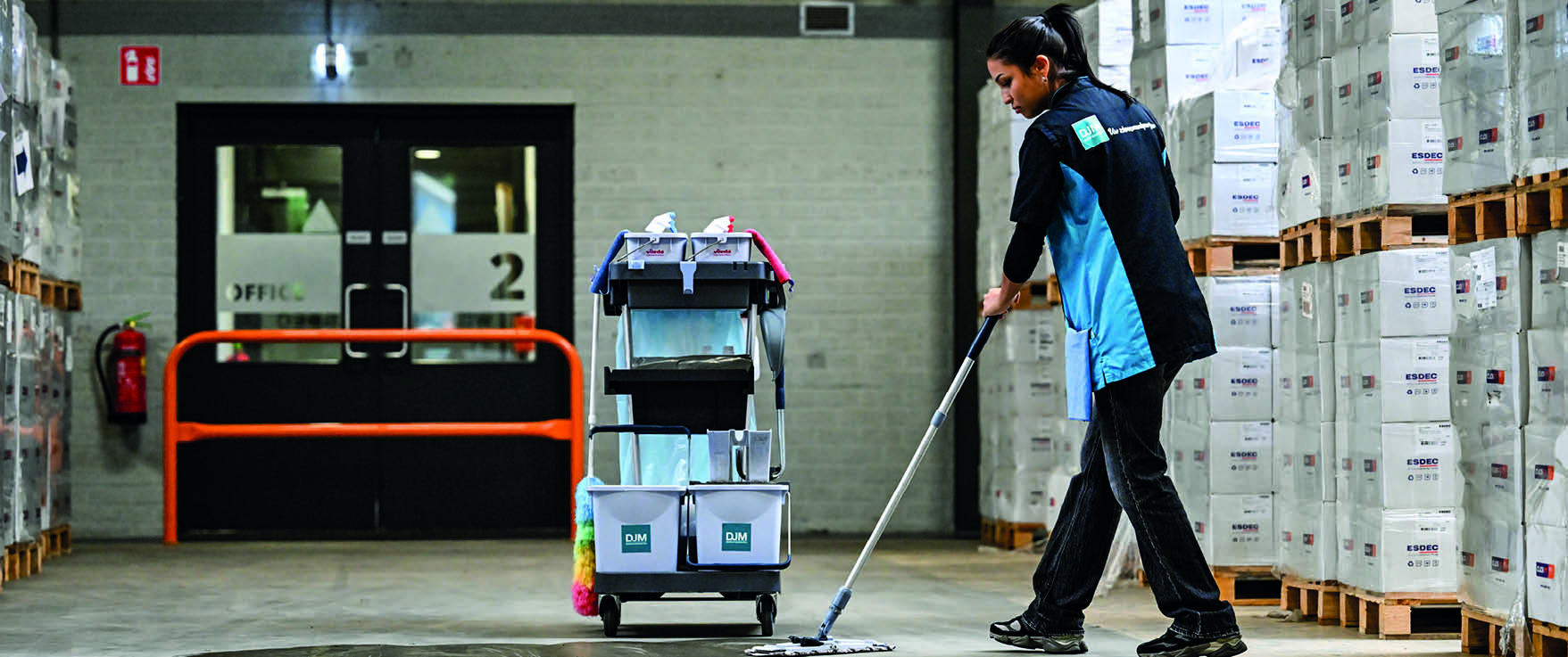 Professionele schoonmaakmachine reinigt de vloer met stoom in een lange gang.