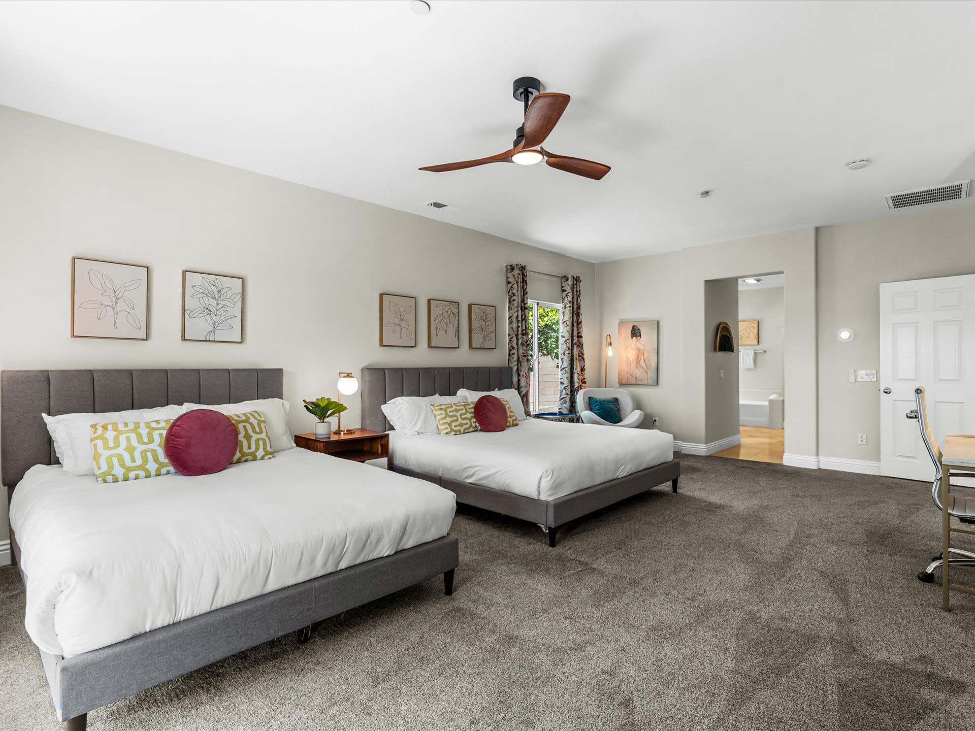 primary bedroom with king and queen beds with ensuite bathroom tropical villa palm springs