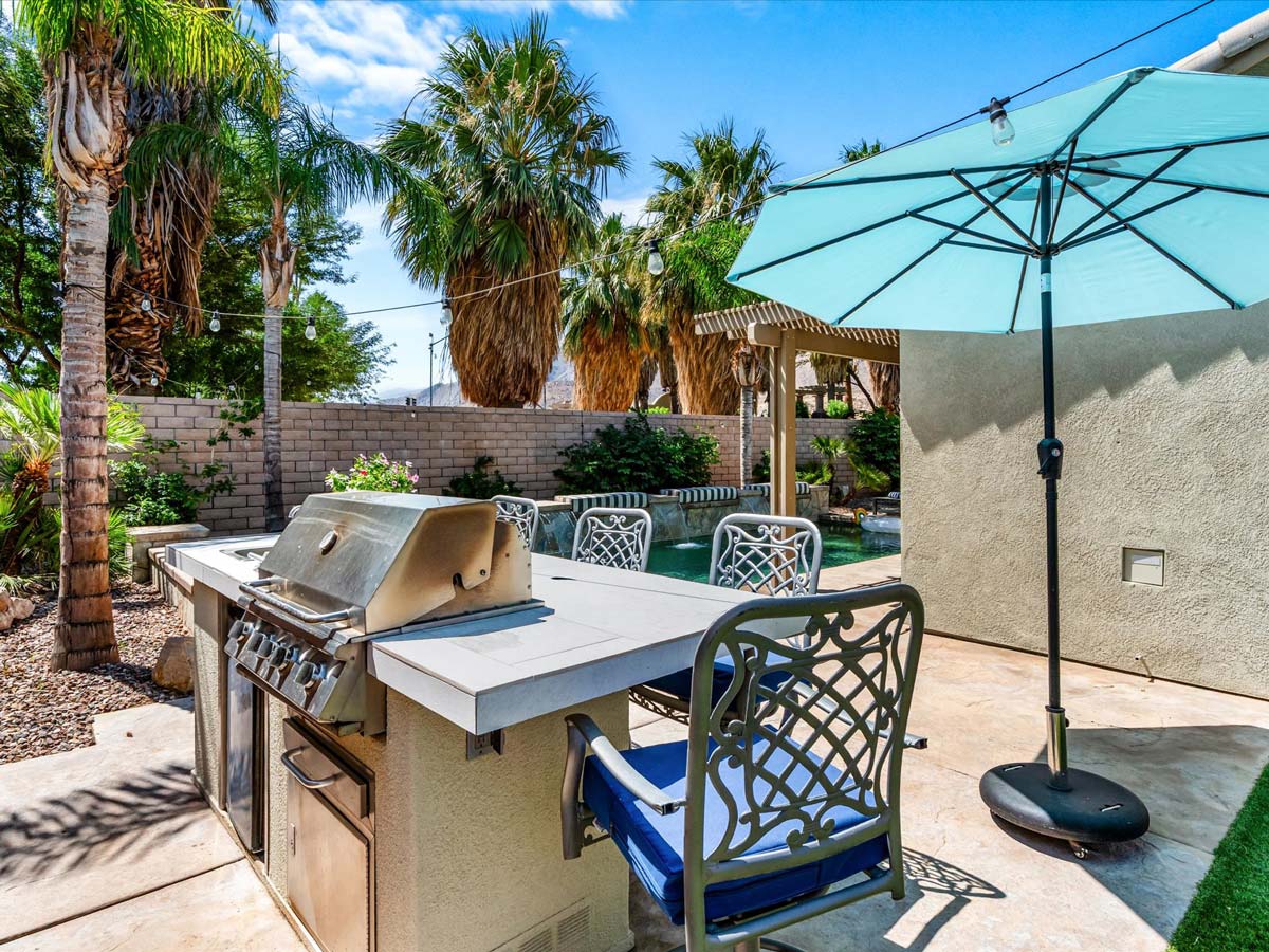 Outdoor grill and dining area patio oasis tropical villa palm springs
