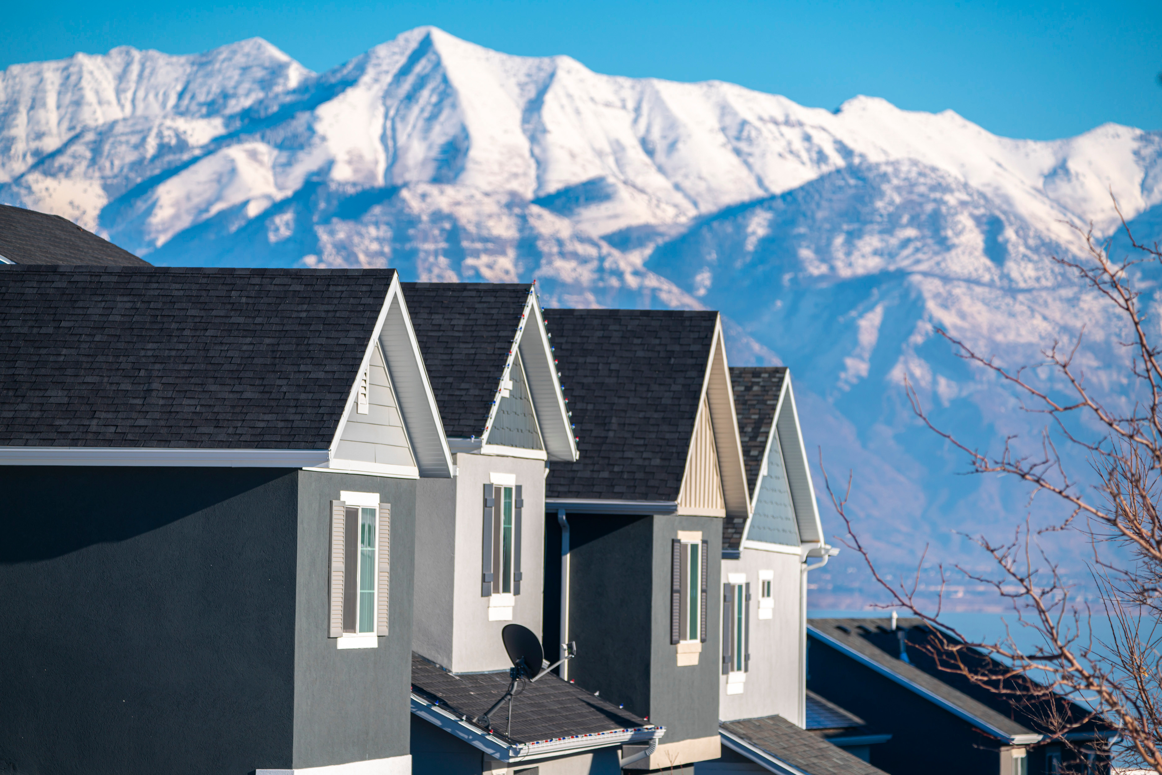 Roof installation with Utah mountains in the background, symbolizing Rime Roofing’s local expertise and pride in the region.