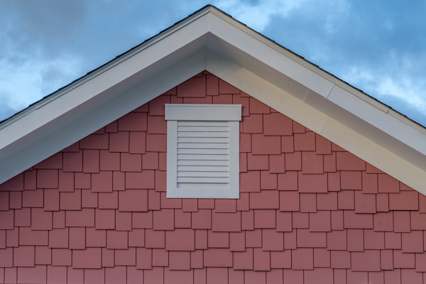 Modern home exterior with roof, siding, gutters, and lighting installed by one trusted team.