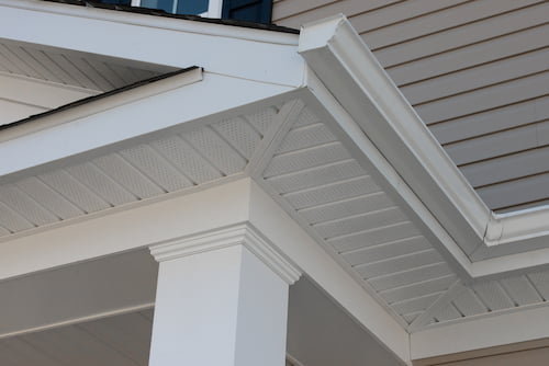 Close-up of gutters, fascia, and ventilated soffit working together to protect a home’s roofline from water damage.