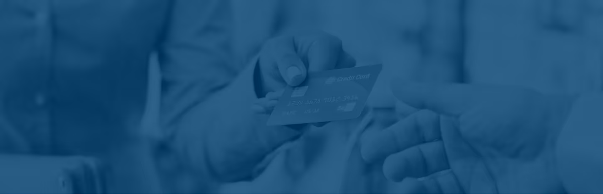 A person handing a credit card to another