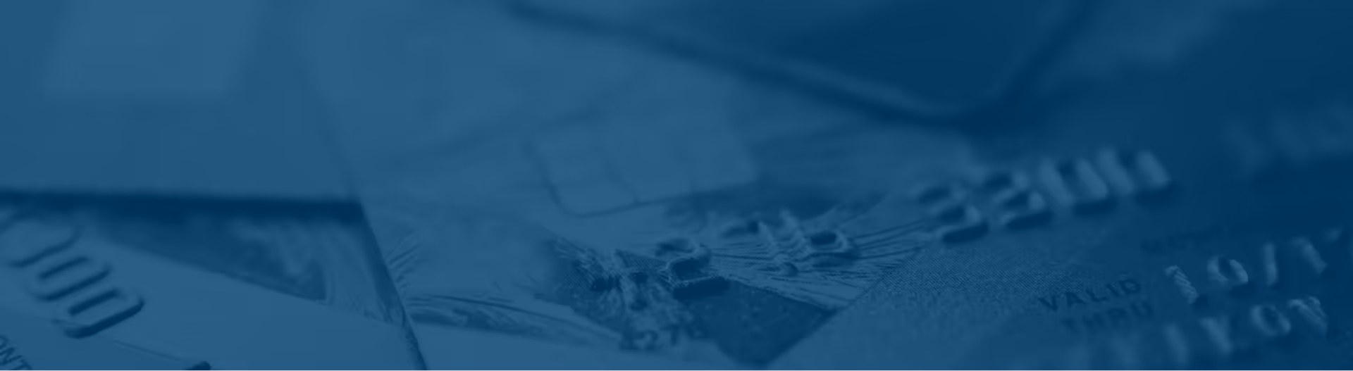Many credit cards laying at a desk