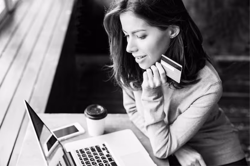 A woman with her credit card buying online