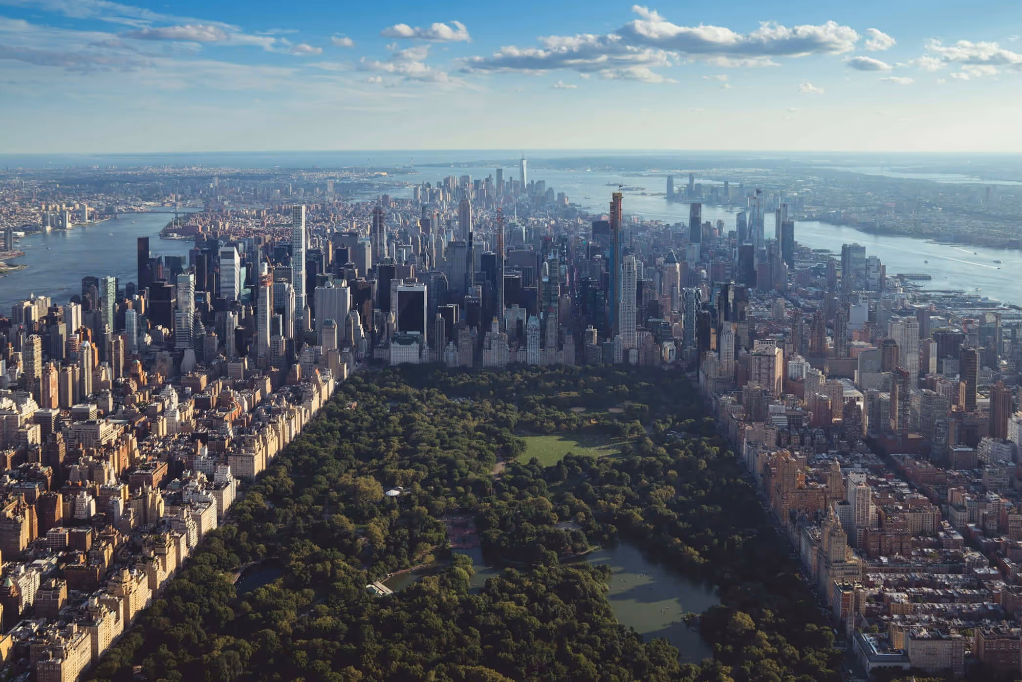 An aerial view of a large city and a lake.
