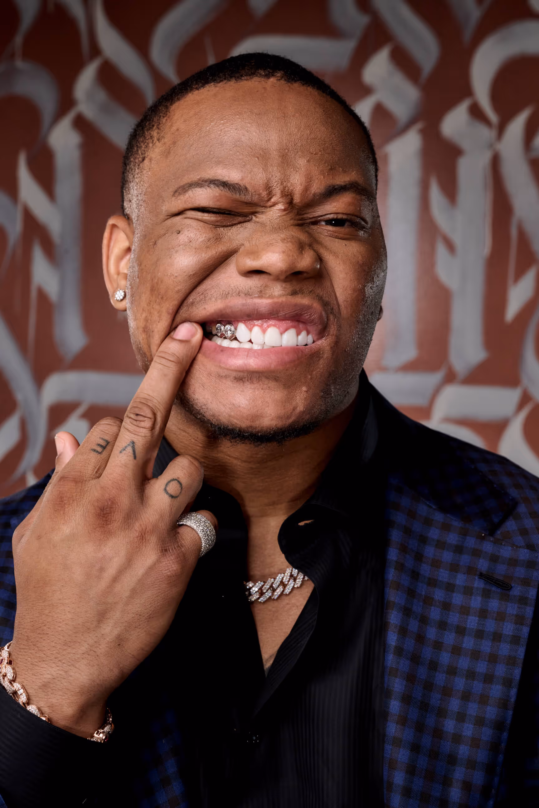 A man holding his finger to his nose.