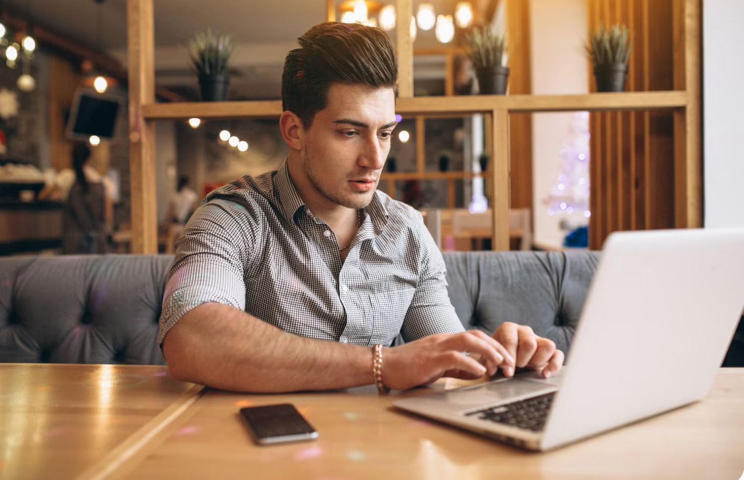 A rehab center staff member using a laptop and implementing strategies on how to increase admissions through compliant marketing