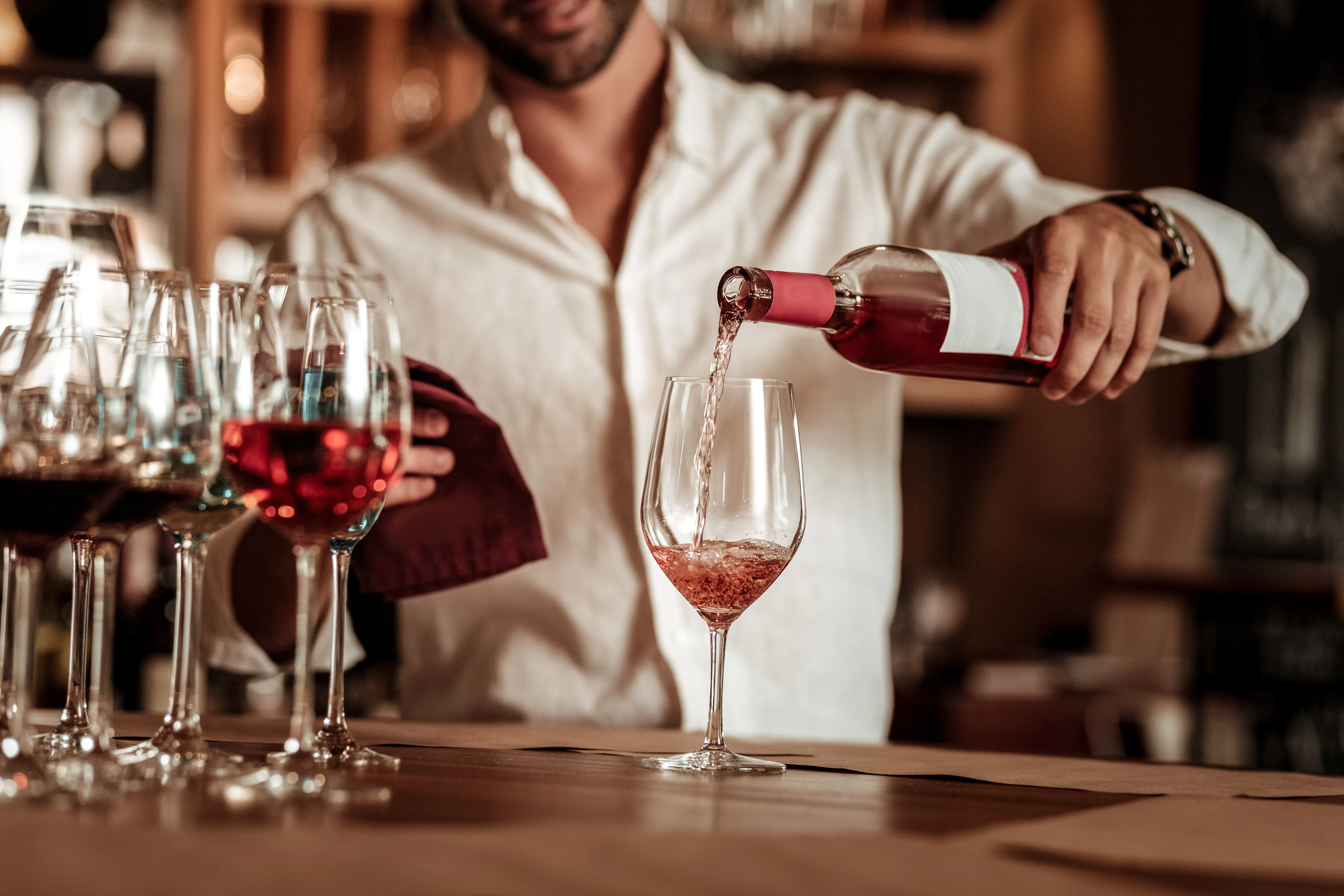 man pouring wine stock image