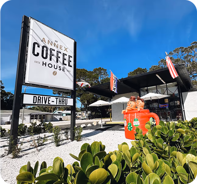 Exterior signage for Annex Coffee House showing cohesive brand identity across storefront and drive-thru environment.