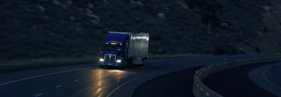 18 wheeler truck driving up a highway