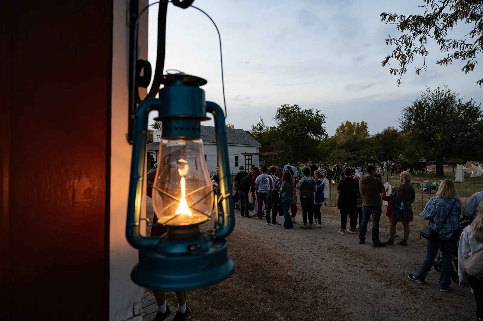 A lantern and line of children at Stuhr Museum's All Hallows Eve halloween event.