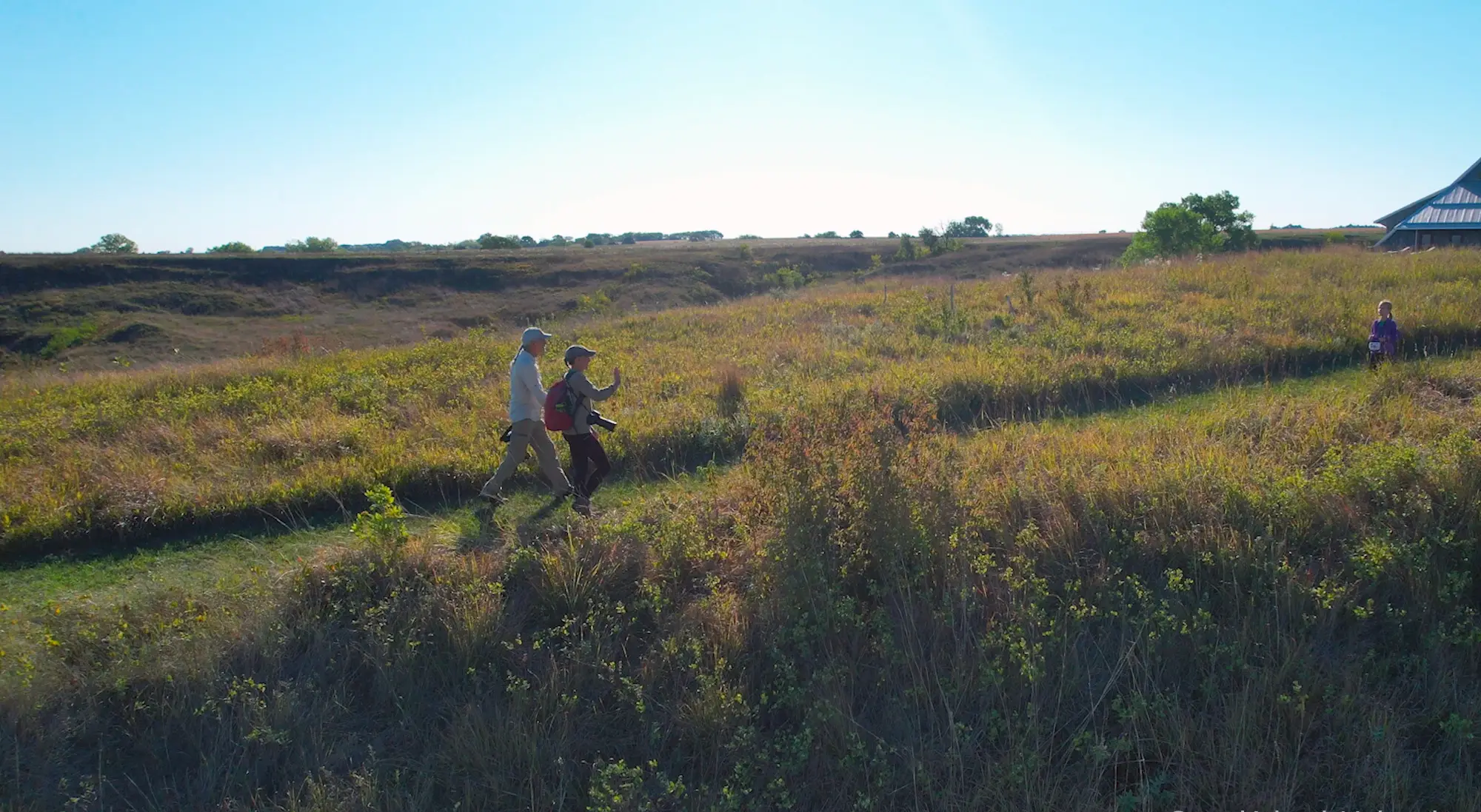 A couple hiking toward the education center at Gjerloff Prairie.