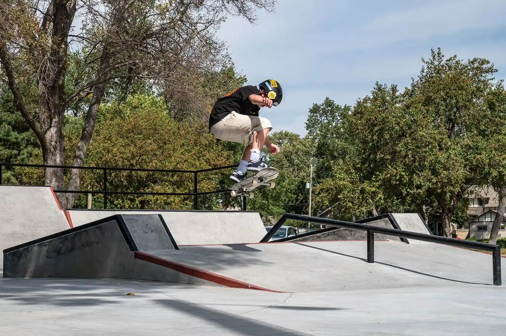 A young boy wearing a helmet jumps at the skate park in Grand Island, Nebraska.