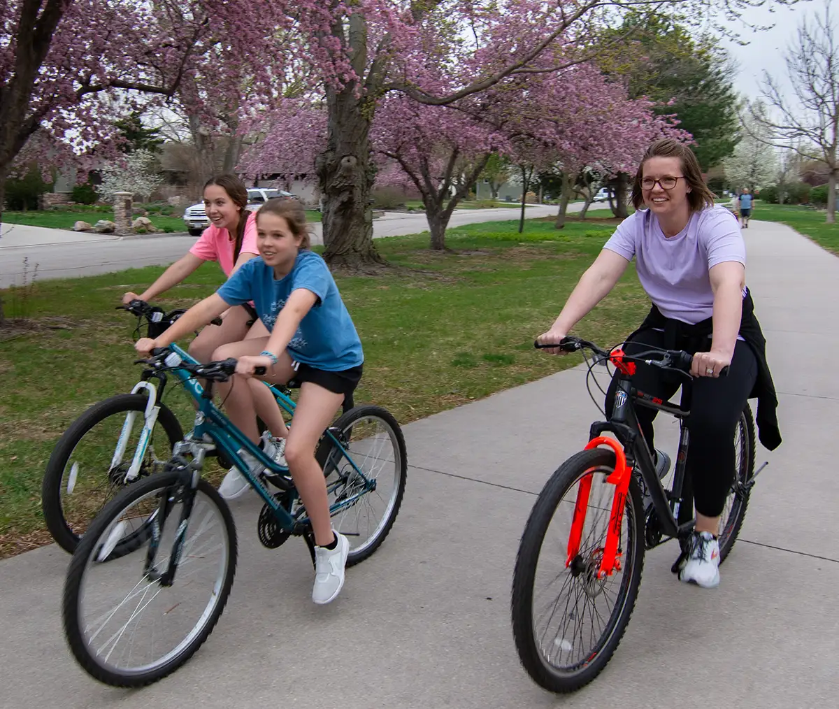A mom and her daughters bicycle along a trail in Grand Island.
