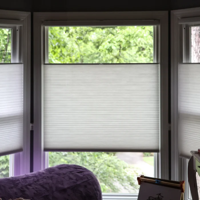 Bay window with staggered light-filtering honeycomb shades