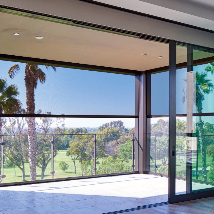 Open-air patio with roll-down shades and palm tree view