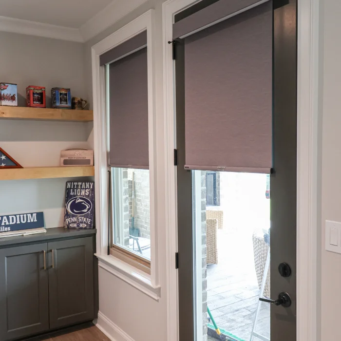 Roller shades on patio door and side window in home office