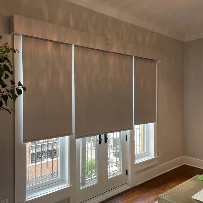 Roller shades covering French doors and side windows in living room