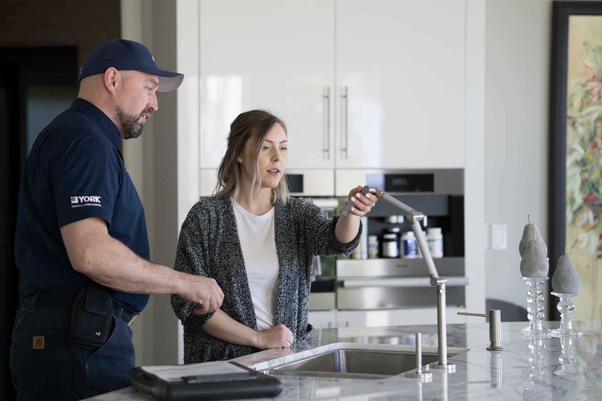 image of plumber working under a sink
