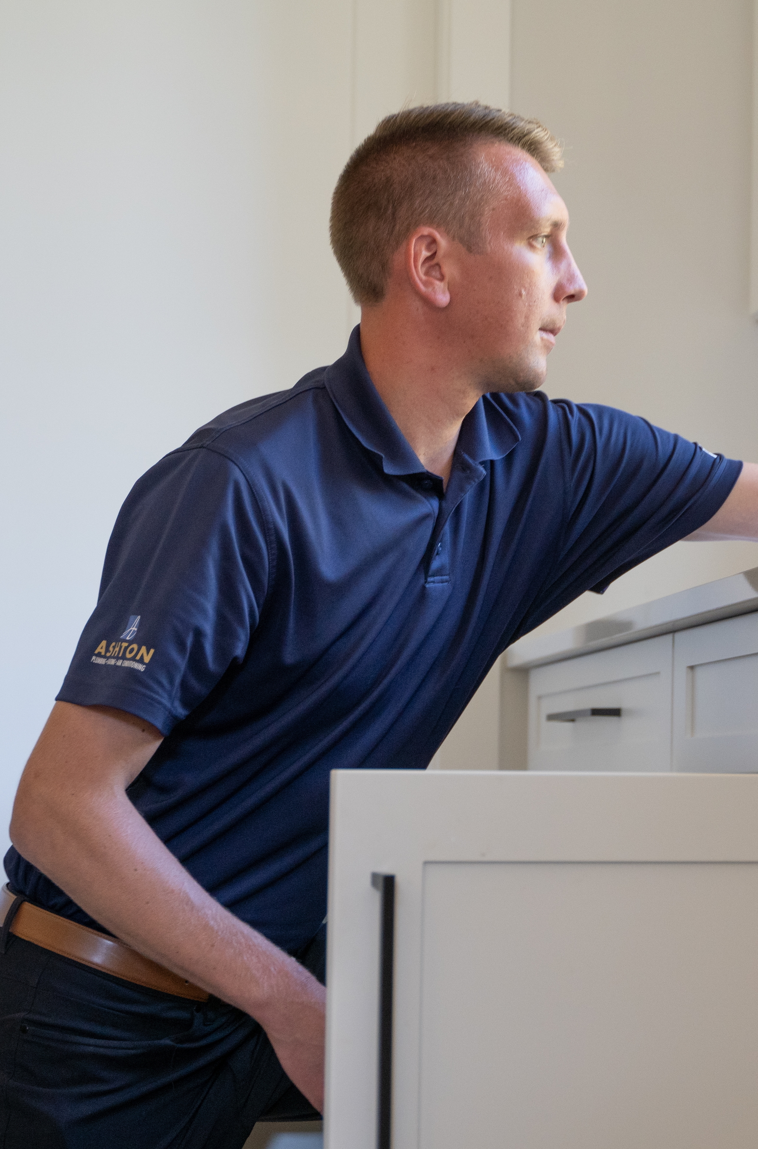 image of plumber working under a sink