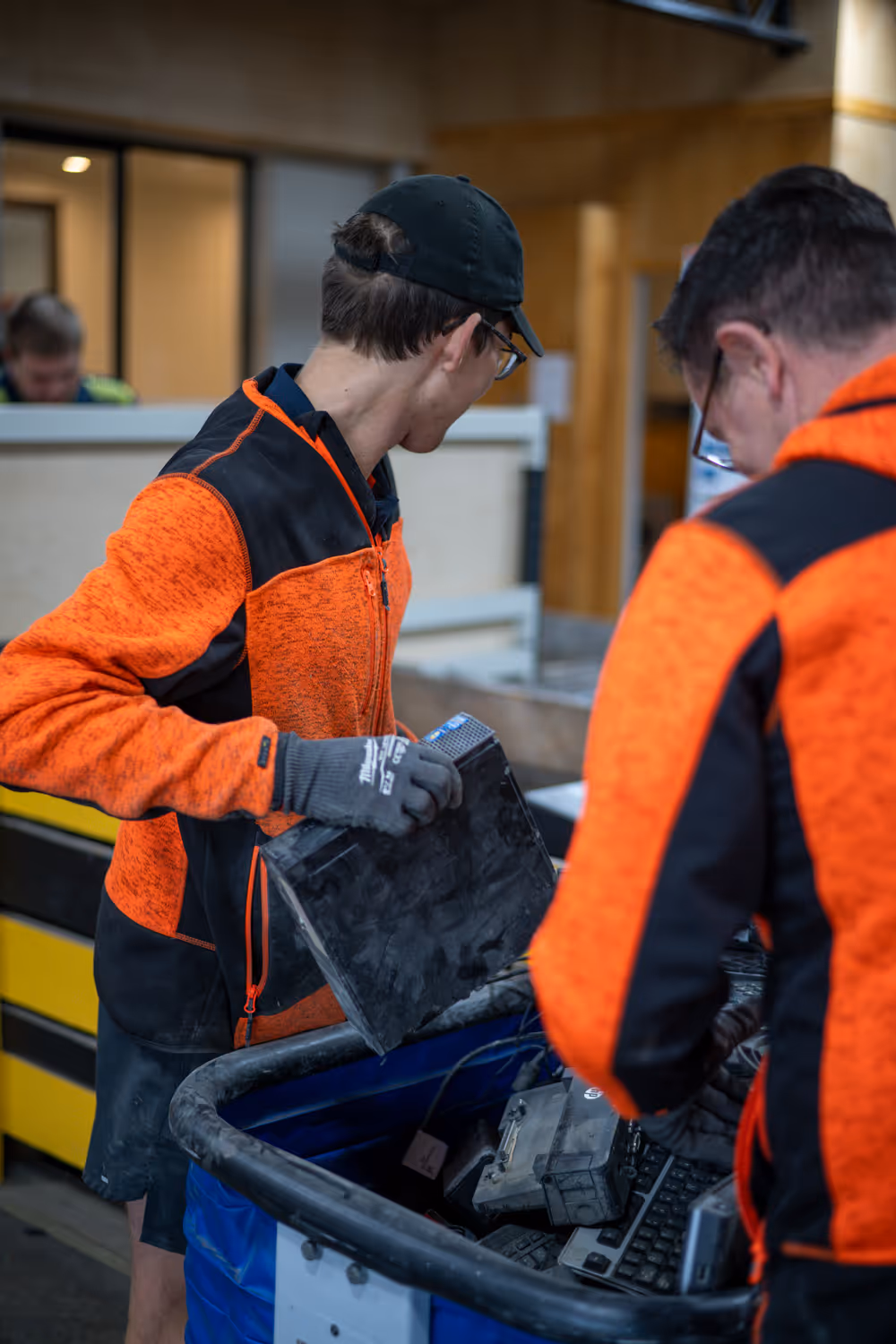 Photo of two team members in the eWaste department sorting through electrical items