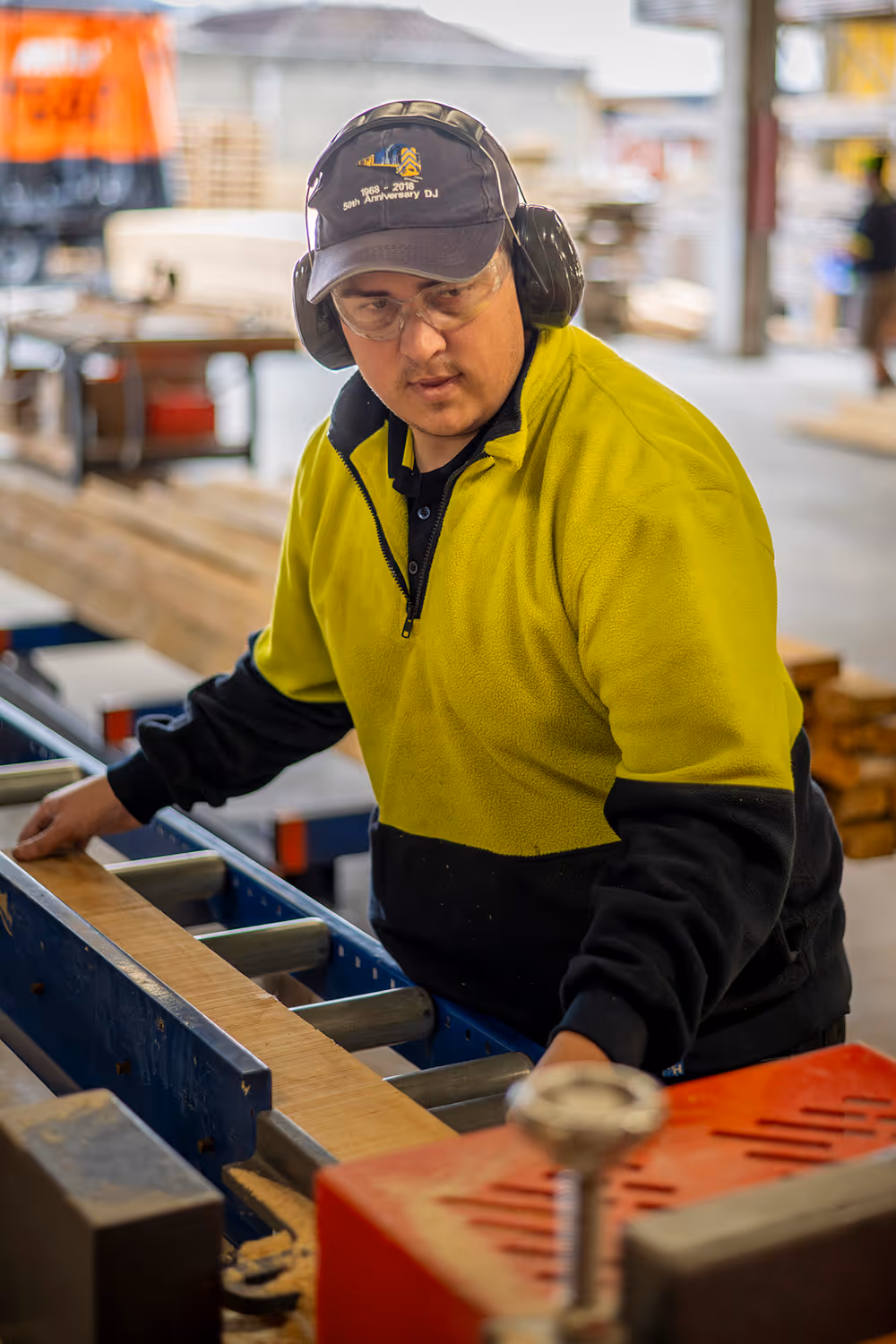 A photo of a timberworks team member cutting wooden planks
