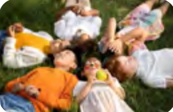 Children lying in a circle on the grass