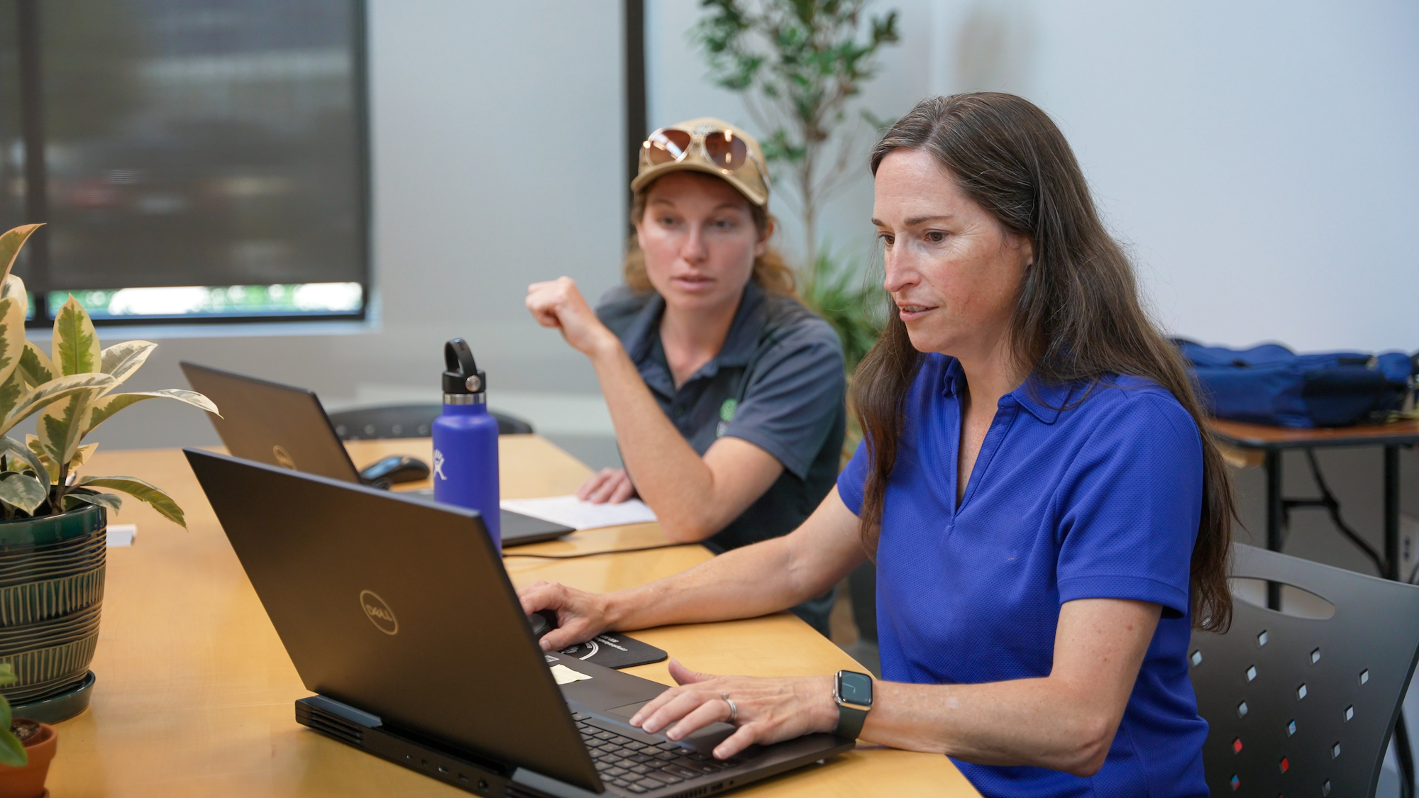 Workers engaged in discussion within a modern office setting.