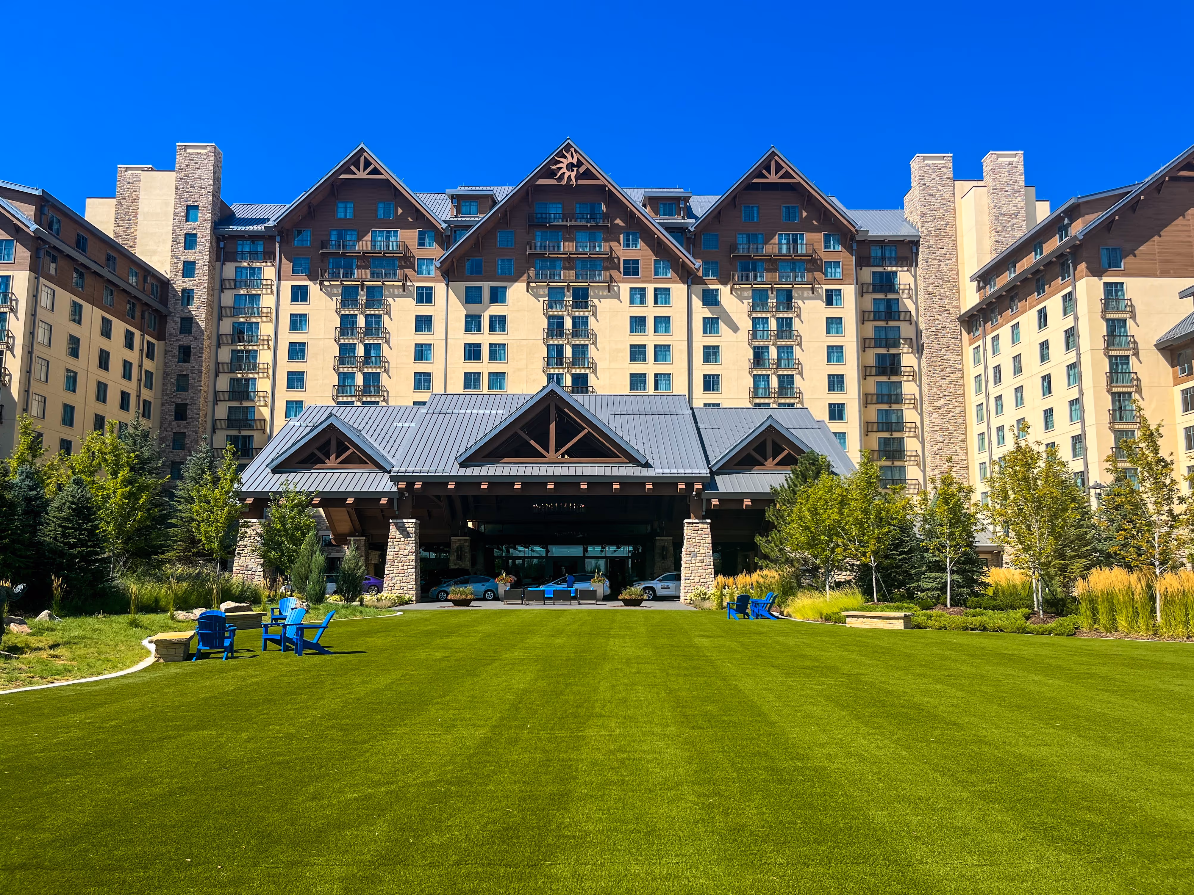 A perfectly mowed lawn stretches across the front entrance of a hotel, creating a warm and welcoming first impression.