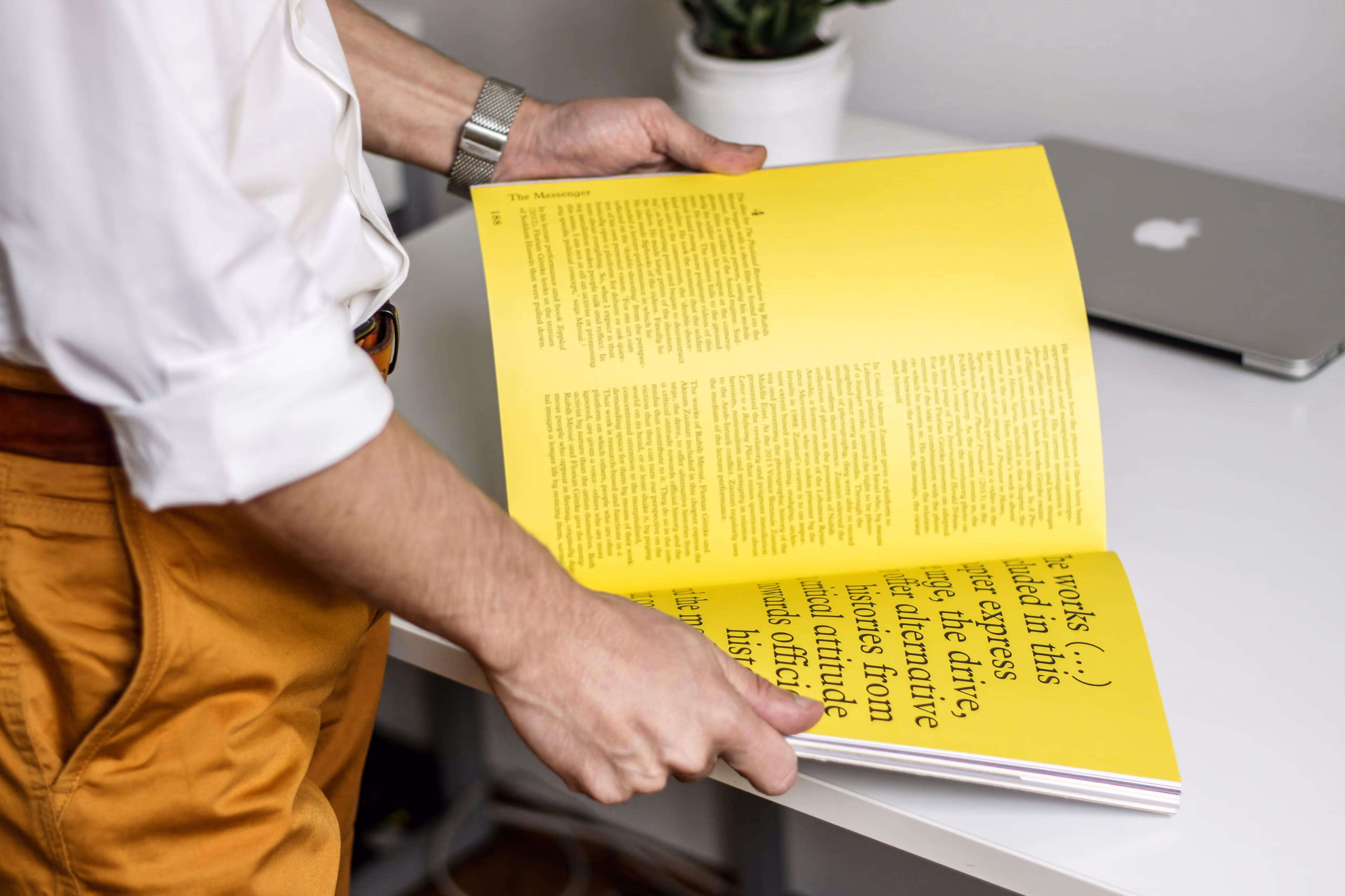 person inspecting a printed magazine or report