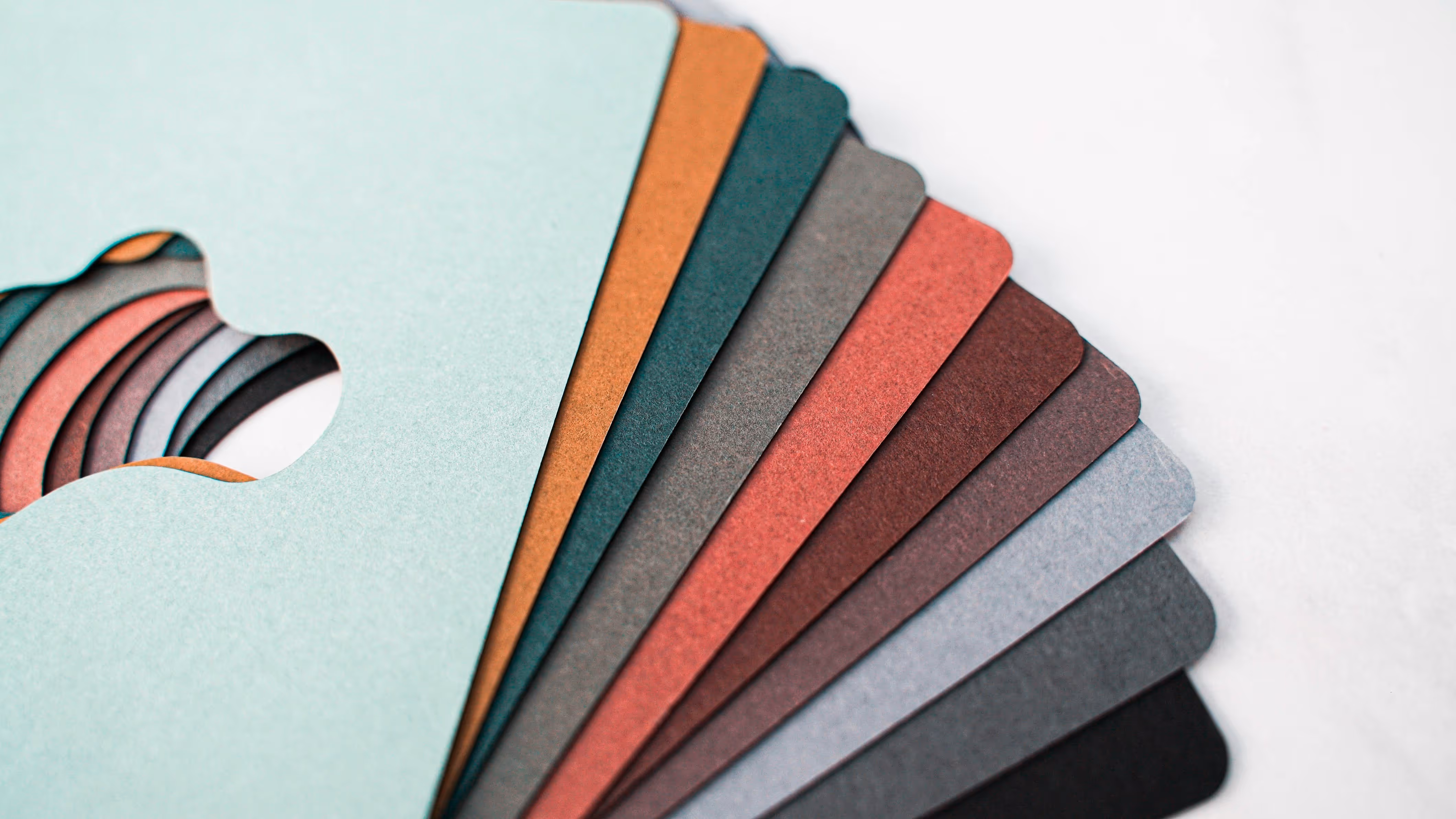 splayed multi-coloured samples of uncoated paper with a die cut shape