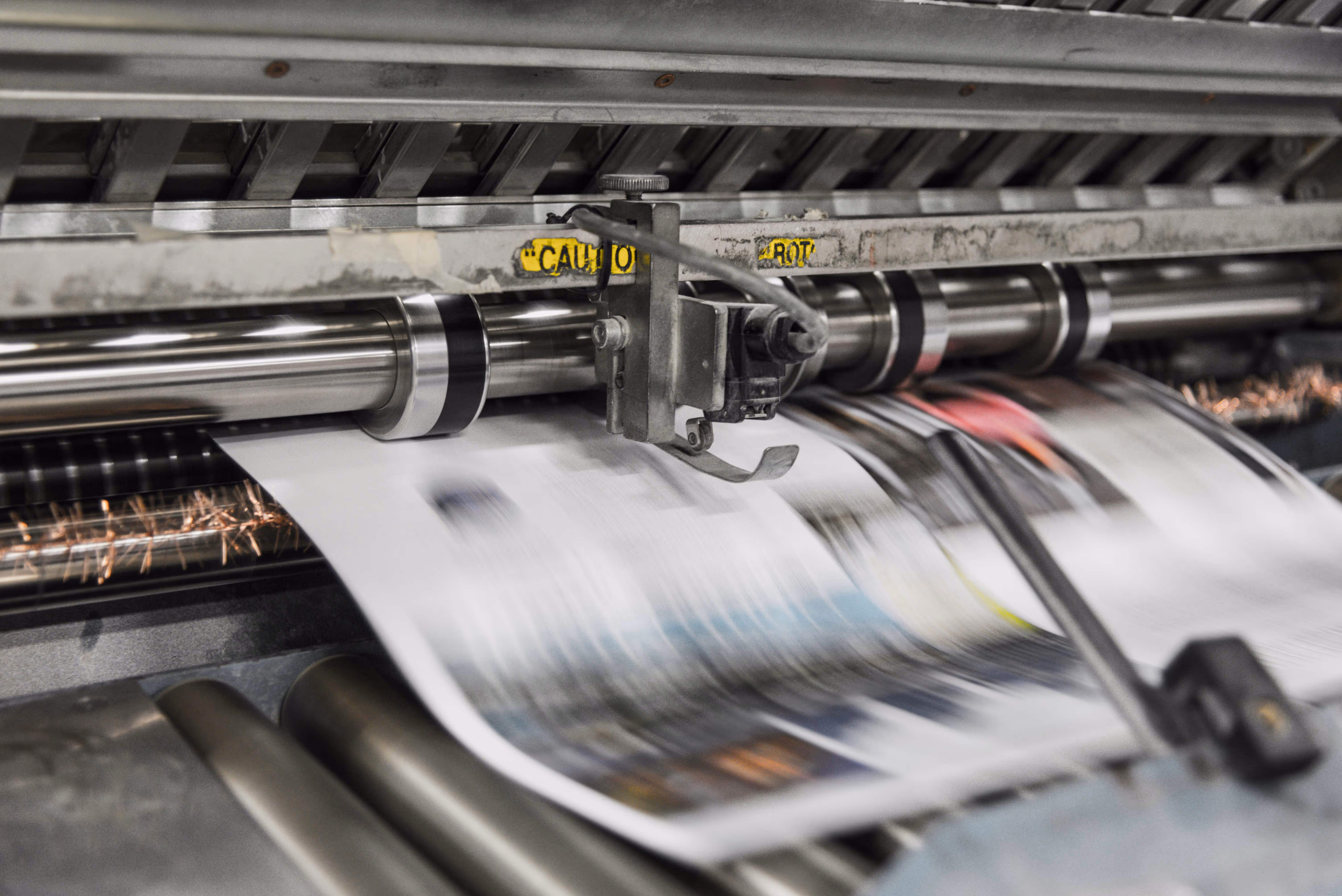 printed pages coming out of commercial printing machine