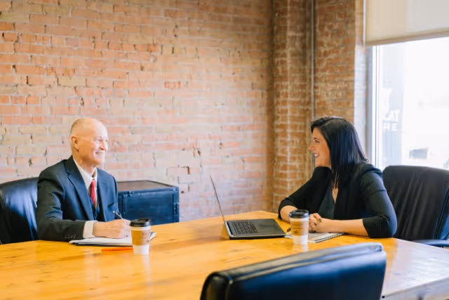 a man and a woman discussing in a meeting