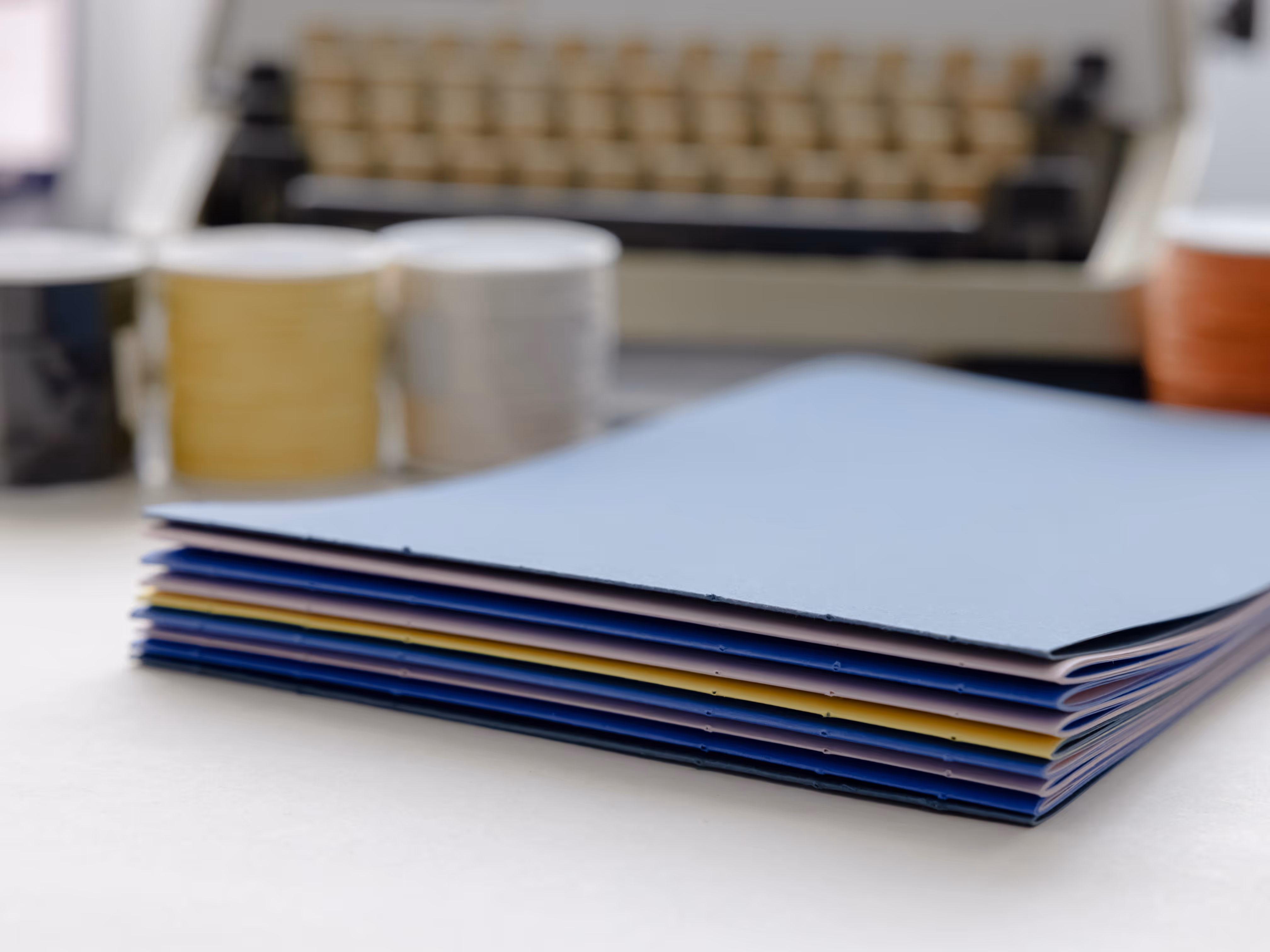 a small stack of thin saddle stitched booklets