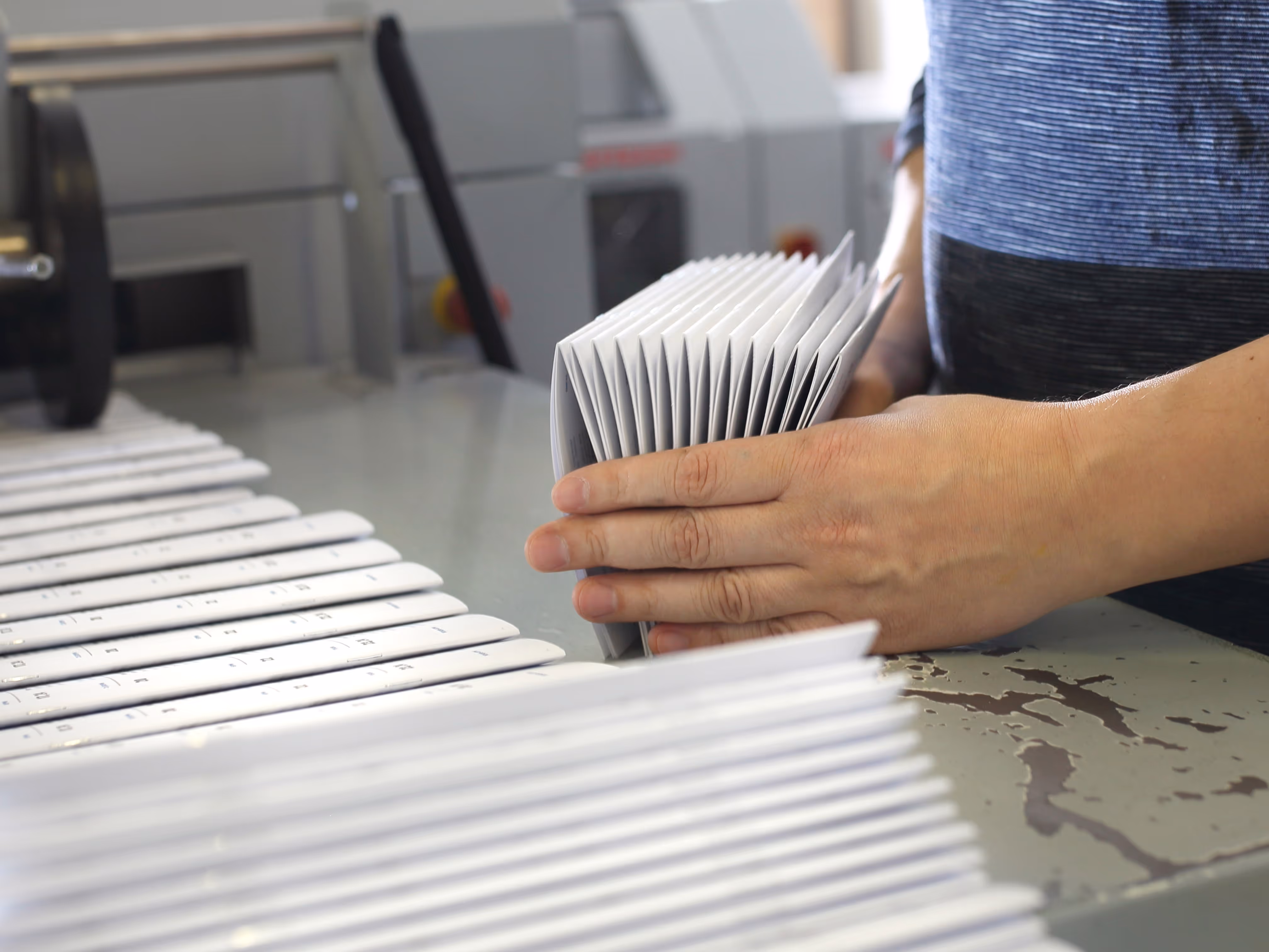 person compiling printed brochures