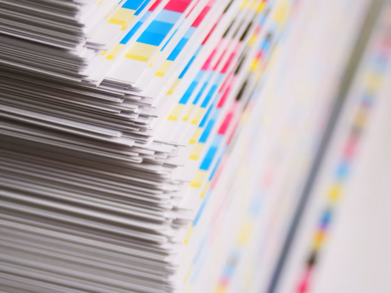 pile of printed page with a CMYK colour key on the edges